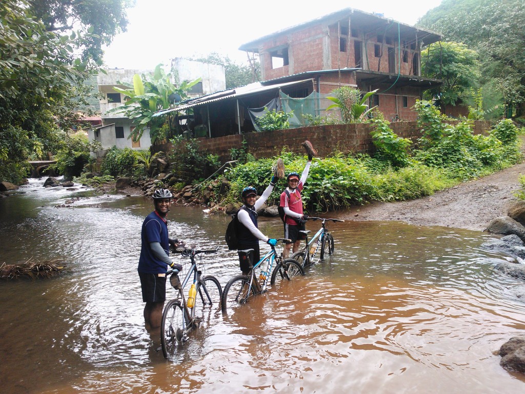 Fellow cyclist crossing a small stream in Murud